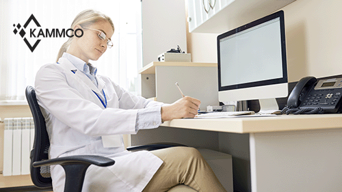 doctor taking notes at a desk