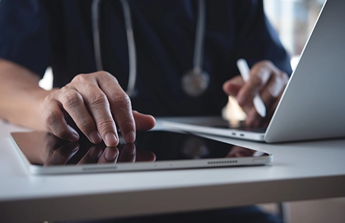 doctor with tablet and computer