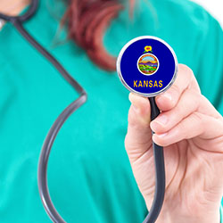 female provider with stethoscope bearing the Kansas state seal - The Fund