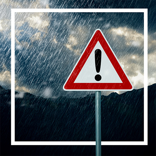warning sign in a storm with extreme weather in the background