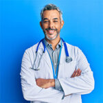 smling doctor on blue backdrop