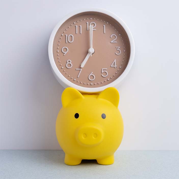 renewal payment timing clock and piggy bank